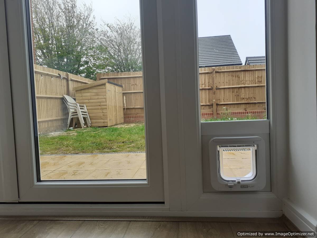 A Sureflap Microchip Pet Door Installed to a narrow glass side light using a narrow glazing conversion kit